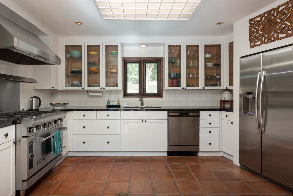 man with quiff and brown tinted sunglasses wearing a fur collar