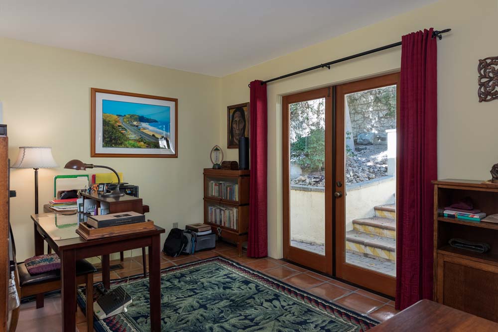 man with quiff and brown tinted sunglasses wearing a fur collar